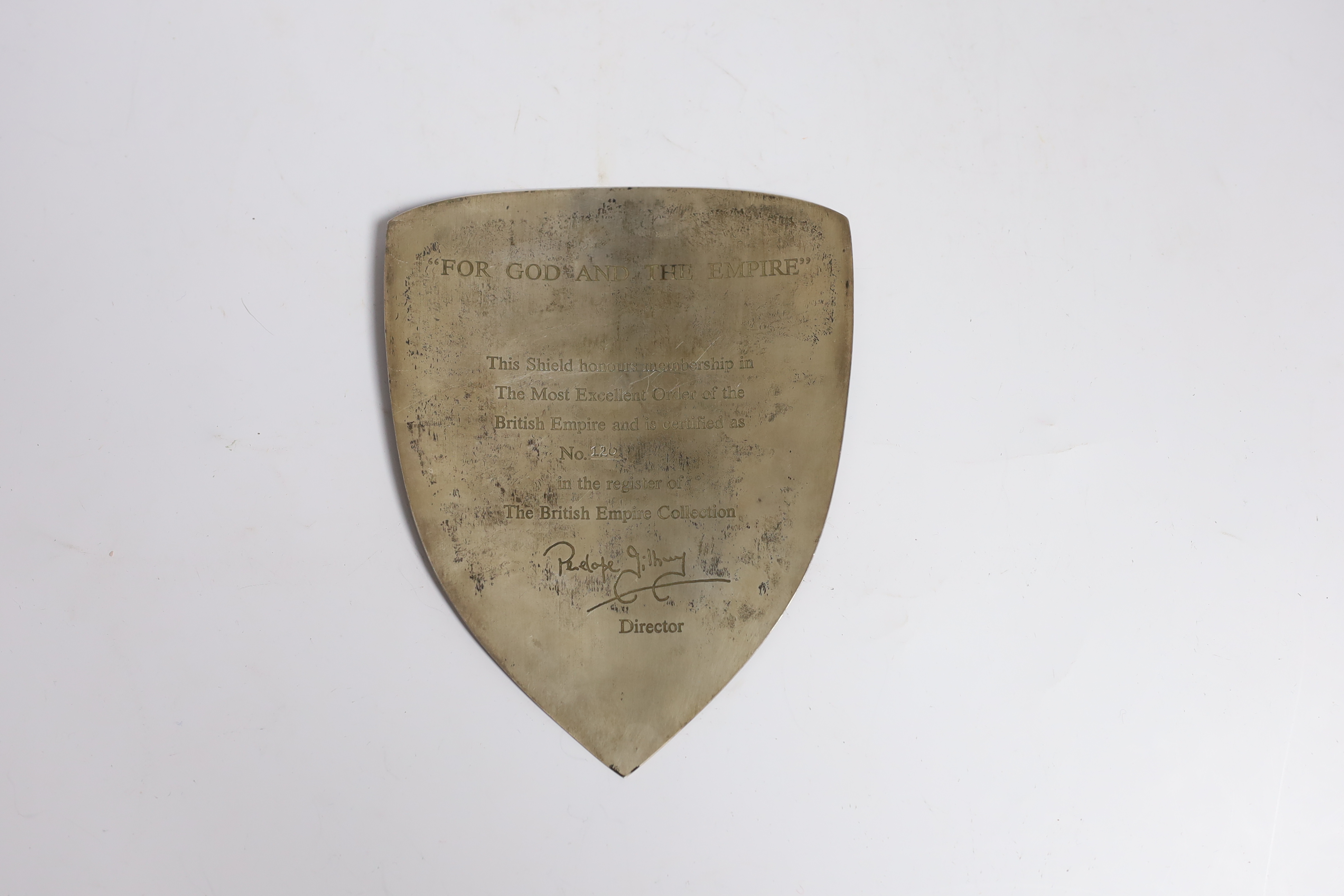 A modern silver shield plaque, engraved 'For God and The Empire. This shield honours membership in The Most Excellent Order of the British Empire and is certified as No. 102 in the register of The British Empire Collecti